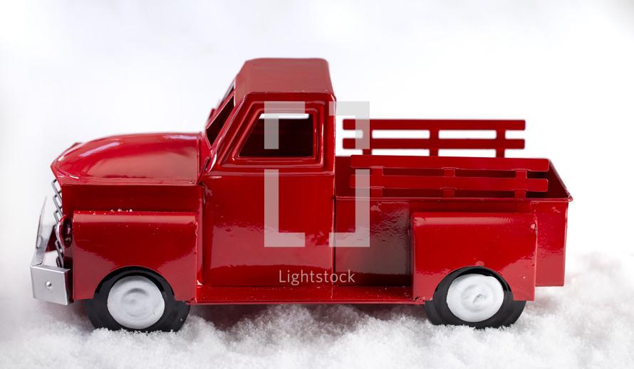 red truck decoration in snow 