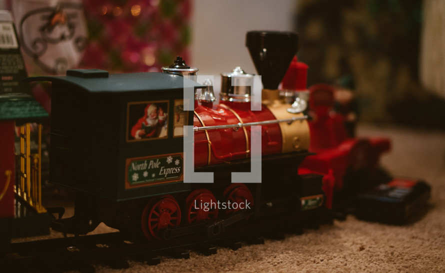 Christmas toy train around a Christmas tree 
