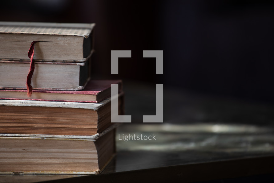 stack of old books on a table 