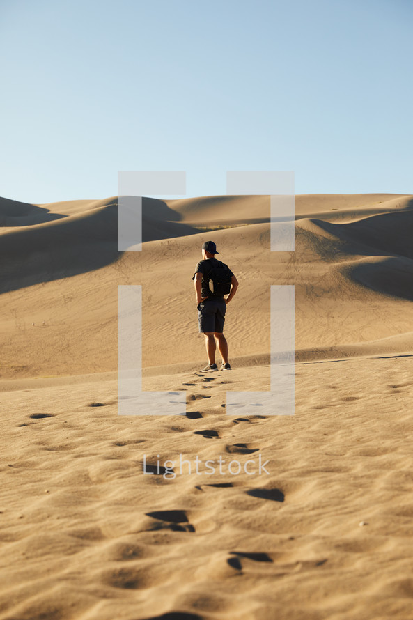 a man exploring sand dunes 