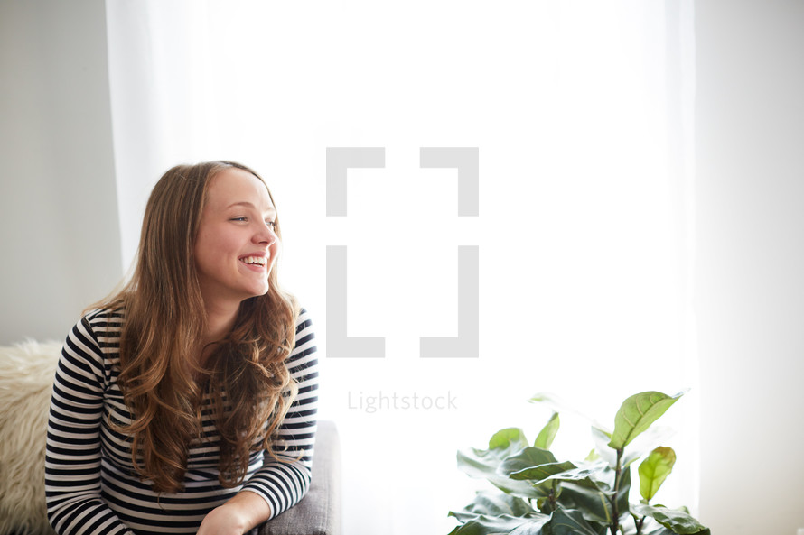 smiling woman sitting in a chair 