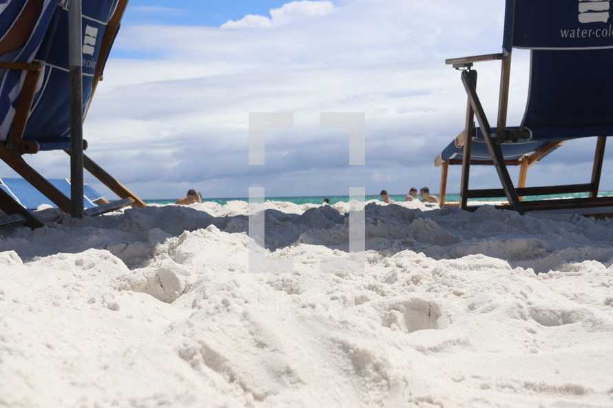 beach chairs in white sand 
