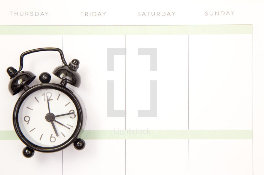 alarm clock on a calendar 
