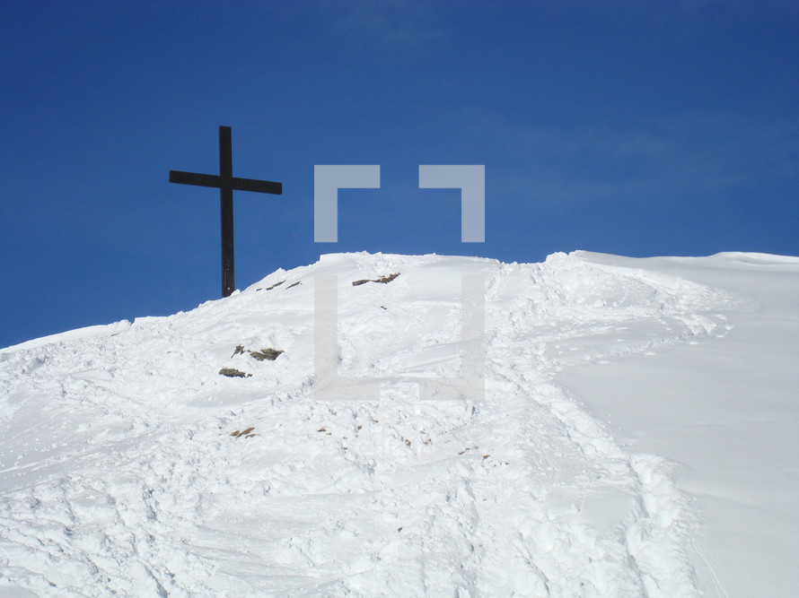 Cross on a snow-covered mountain top, 
