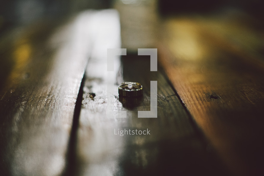 Wedding ring set on a wood table.