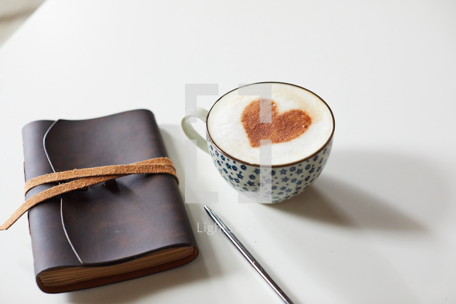 cinnamon heart in a coffee cup, pen, and Leather bound journal 
