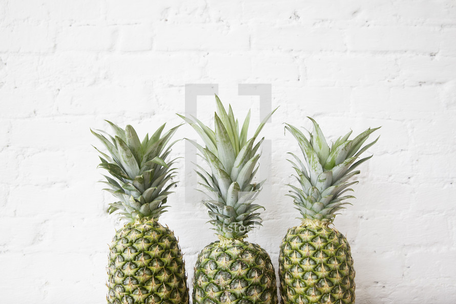 a row of three pineapples 