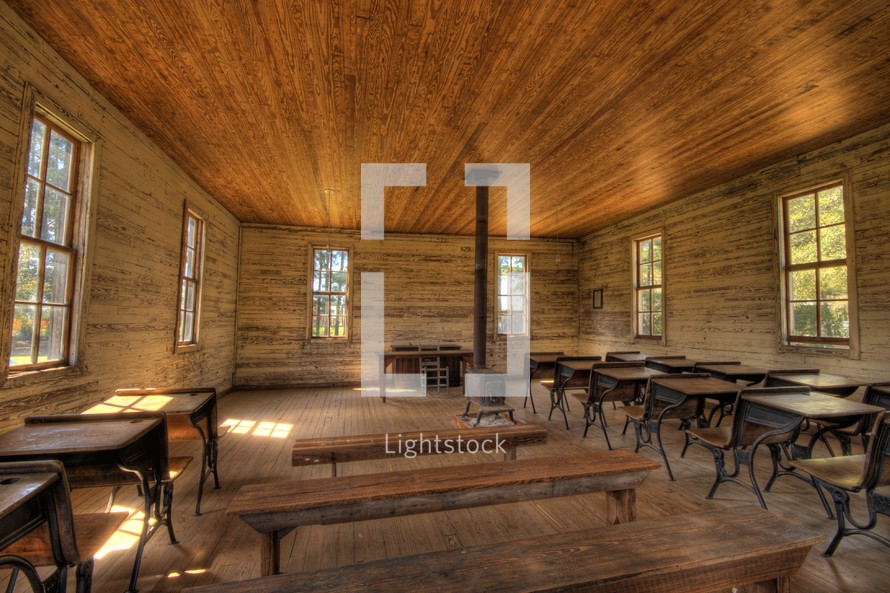 an old schoolhouse, desks, and wood stove 