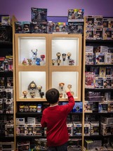 a child in a toy store shopping for collectibles 