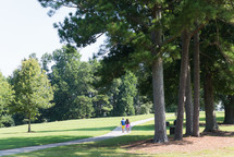 couple walking on a path in a park in summer 