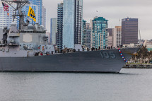 Navy Ship entering bay with city skyline in background San Diego men lining deck shipmate homecoming