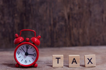 alarm clock and word tax 