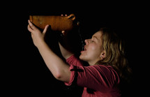 a woman drinking water from a jug