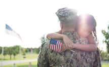 soldier hugging his daughter 