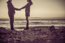 couple holding hands on a beach