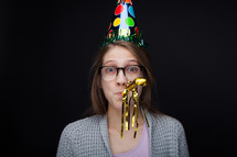 a young woman in a party hat 