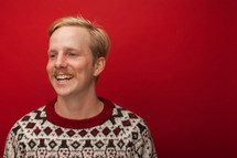 a man with a mustache in Christmas sweater 
