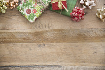 border of Christmas gifts on wood 