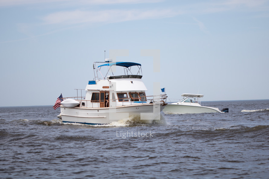 Luxury boats traveling through Lake Michigan at Grand Haven State Park in Grand Haven, Michigan, western Michigan, Great Lakes