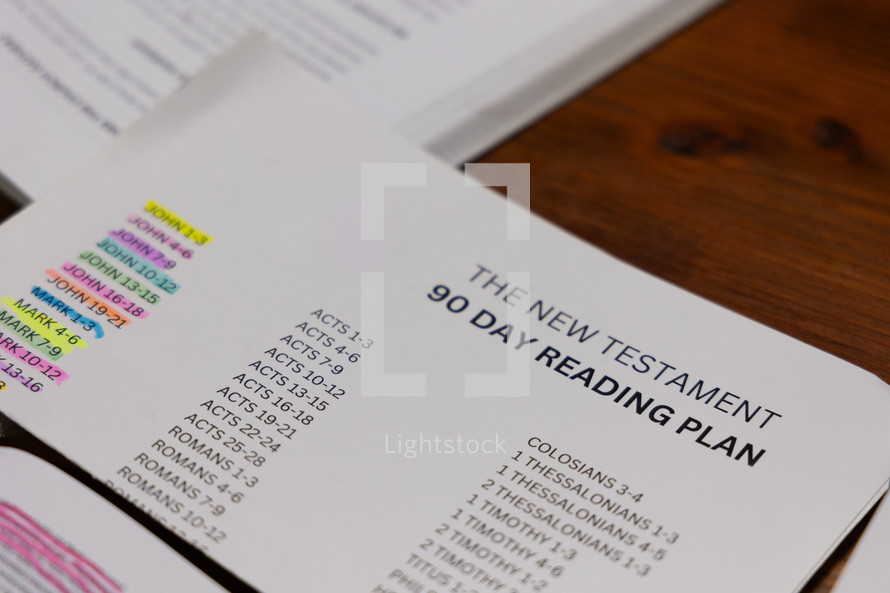 Close up of New Testament reading plan paper on table during Bible study