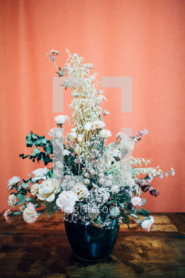 a flower arrangement on a wood table 