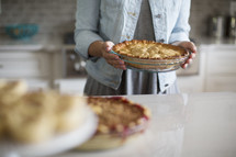 a woman holding a pie