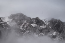 fog over jagged mountain peaks 