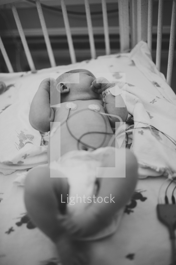 a newborn in a hospital nursery 