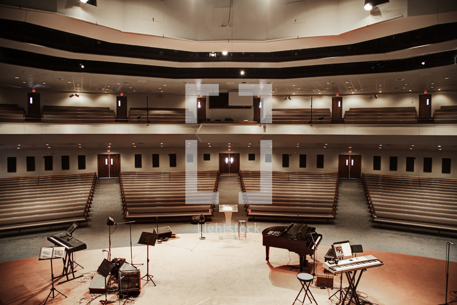 Auditorium with a stage and musical instruments.