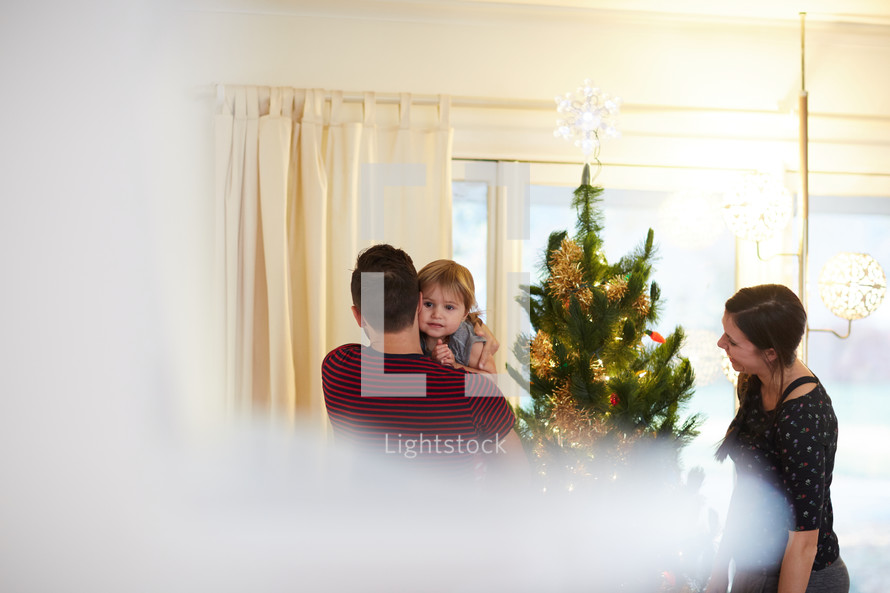 a family decorating a Christmas tree