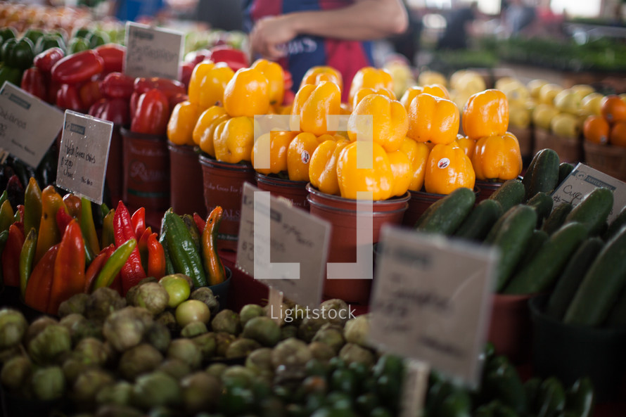 variety of peppers and tomatillos for sale at a farmers market  