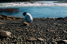 a person looking for seashells 