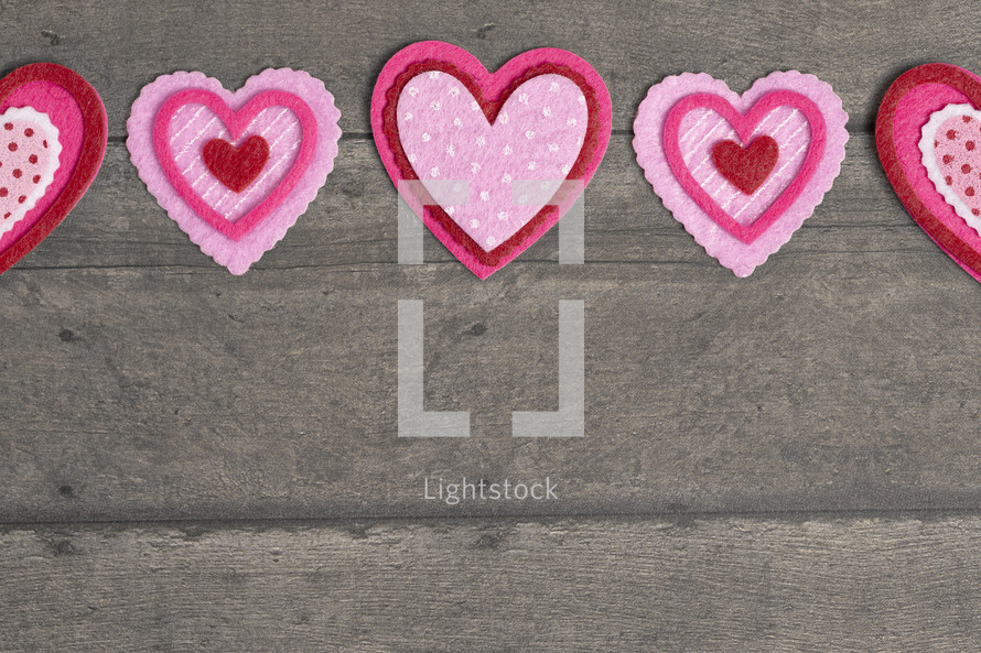 Simple Background with Felt Love Hearts on a gray wood  Background