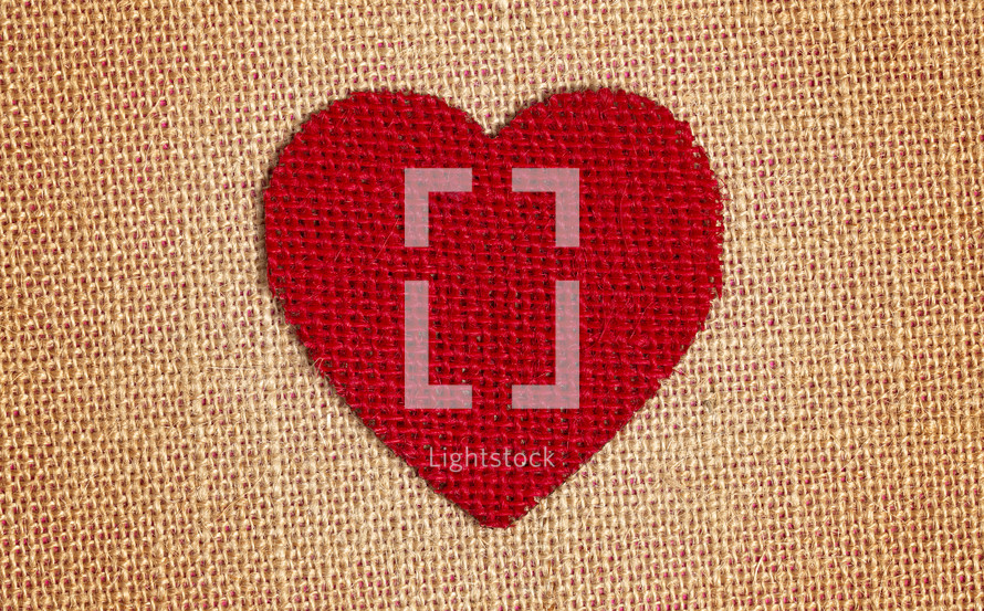 Red Burlap Heart on a brown burlap Background