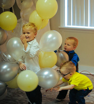 toddlers playing with helium balloons 