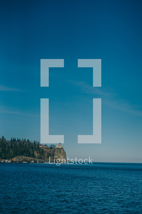 distant lighthouse on a cliff 