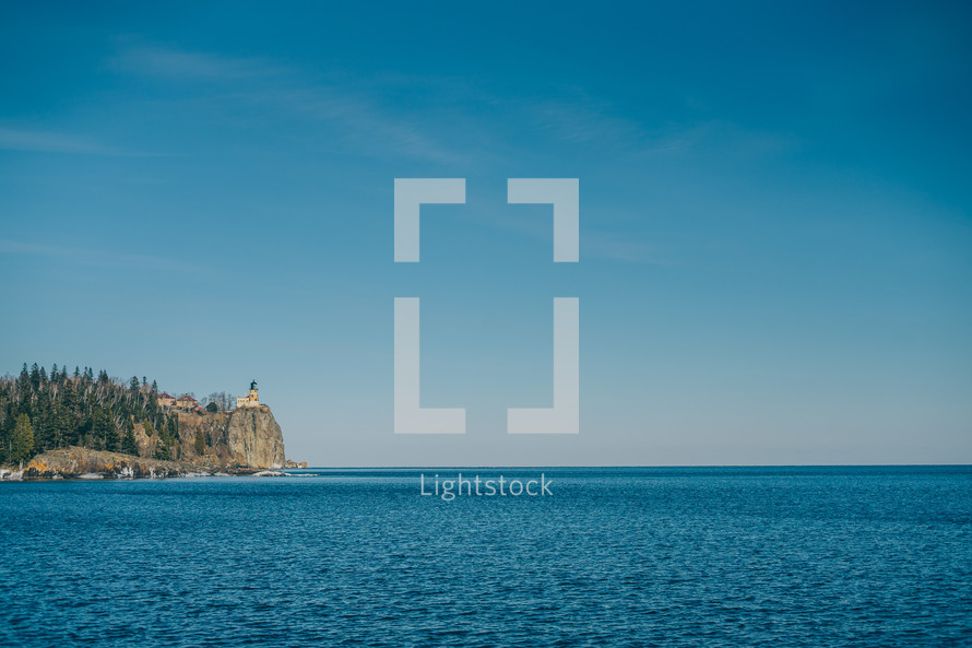 distant lighthouse on a cliff