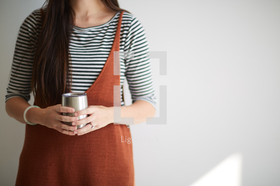a woman holding a coffee cup