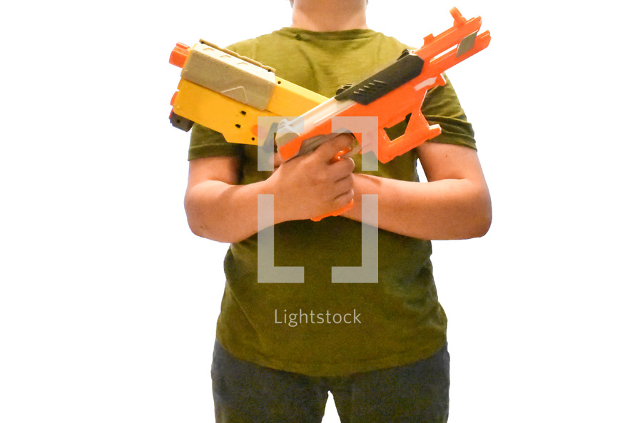 a boy child holding nerf guns 