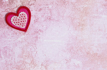 Simple Background with Felt Love Hearts on a pink background 