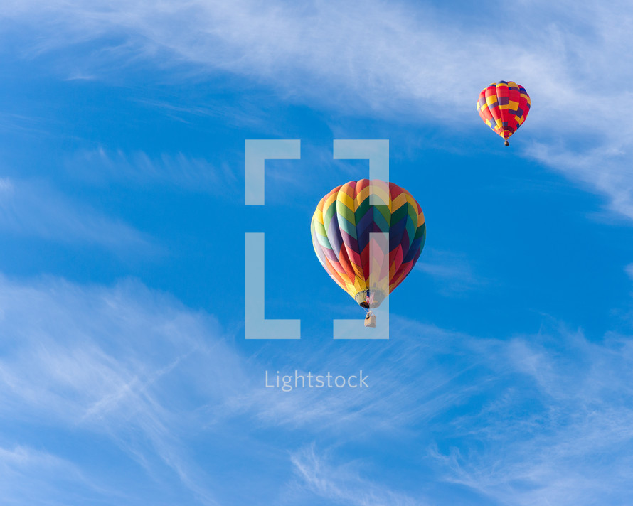 colorful hot air balloons in a blue sky 