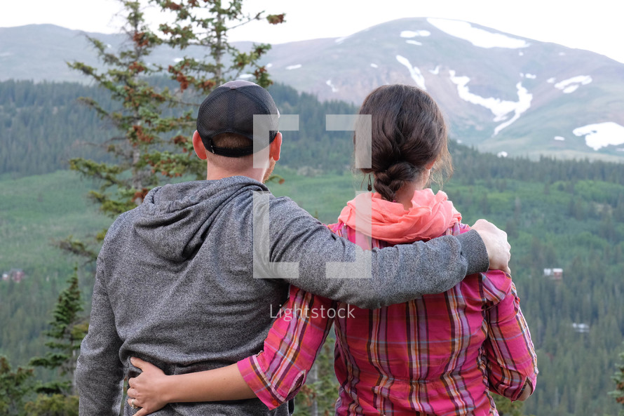 a couple in front of a mountain view 