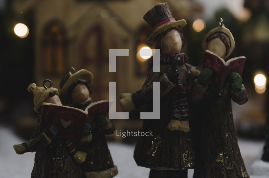carolers in a Christmas village 