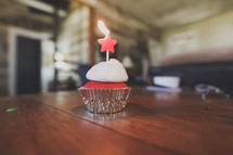 A birthday cupcake with a star on top