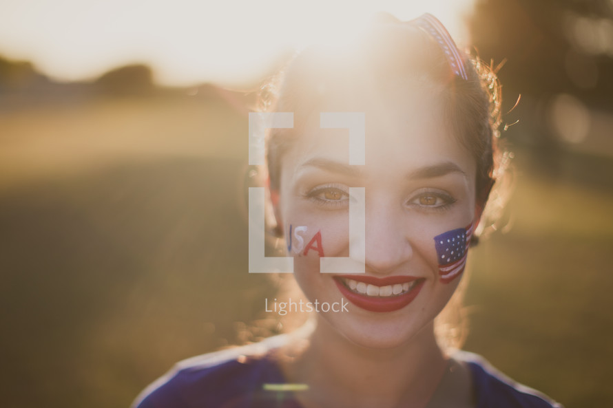 A young woman with American flag face paint