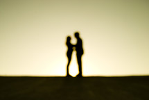 Couple in love on a rooftop. Out of focus.