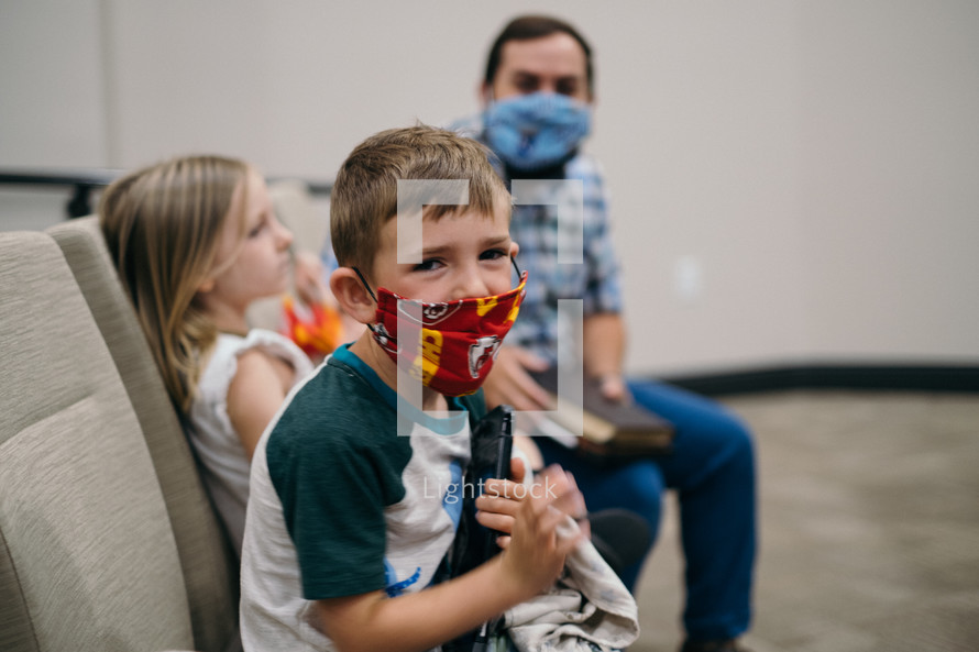 family at church wearing face masks 