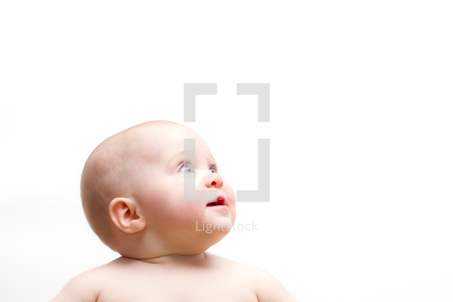face of an infant looking up 