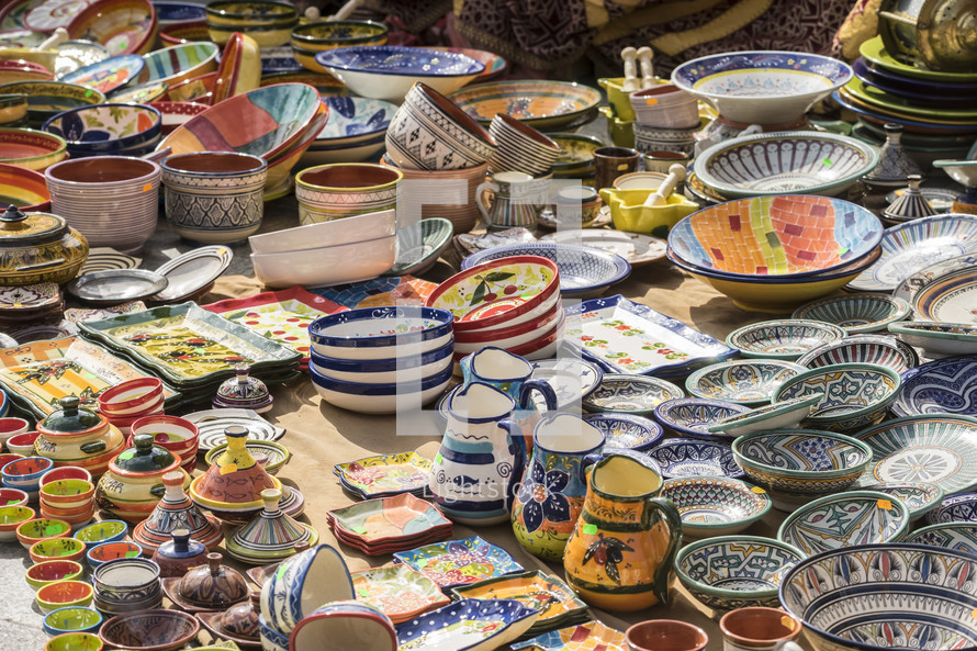 colorful bowls and porcelain pitchers at a market 