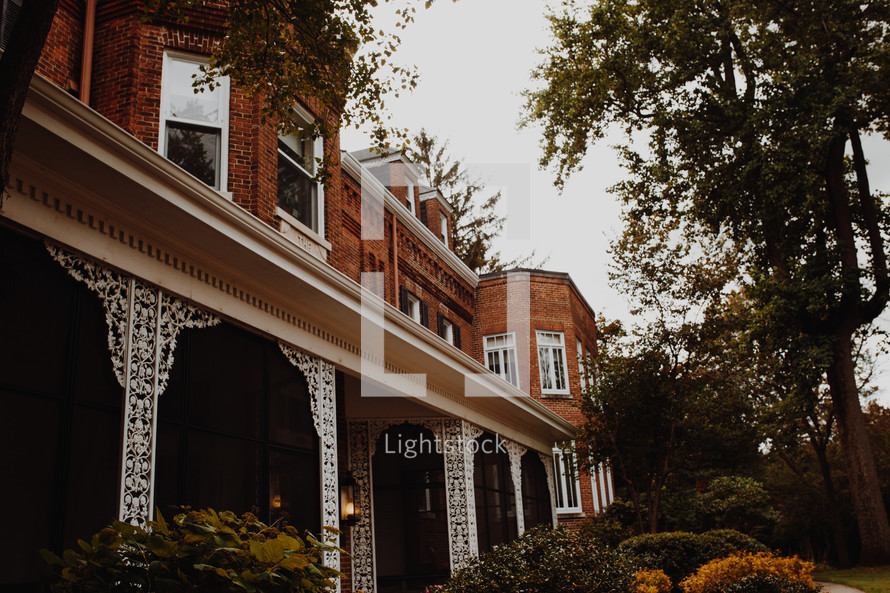 front porch of an historic brick home 
